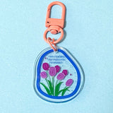 Keychain with pink tulips design on a light blue background