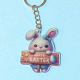 acrylic Keychain with a cartoon bunny holding a 'Happy Easter' sign on a light blue background