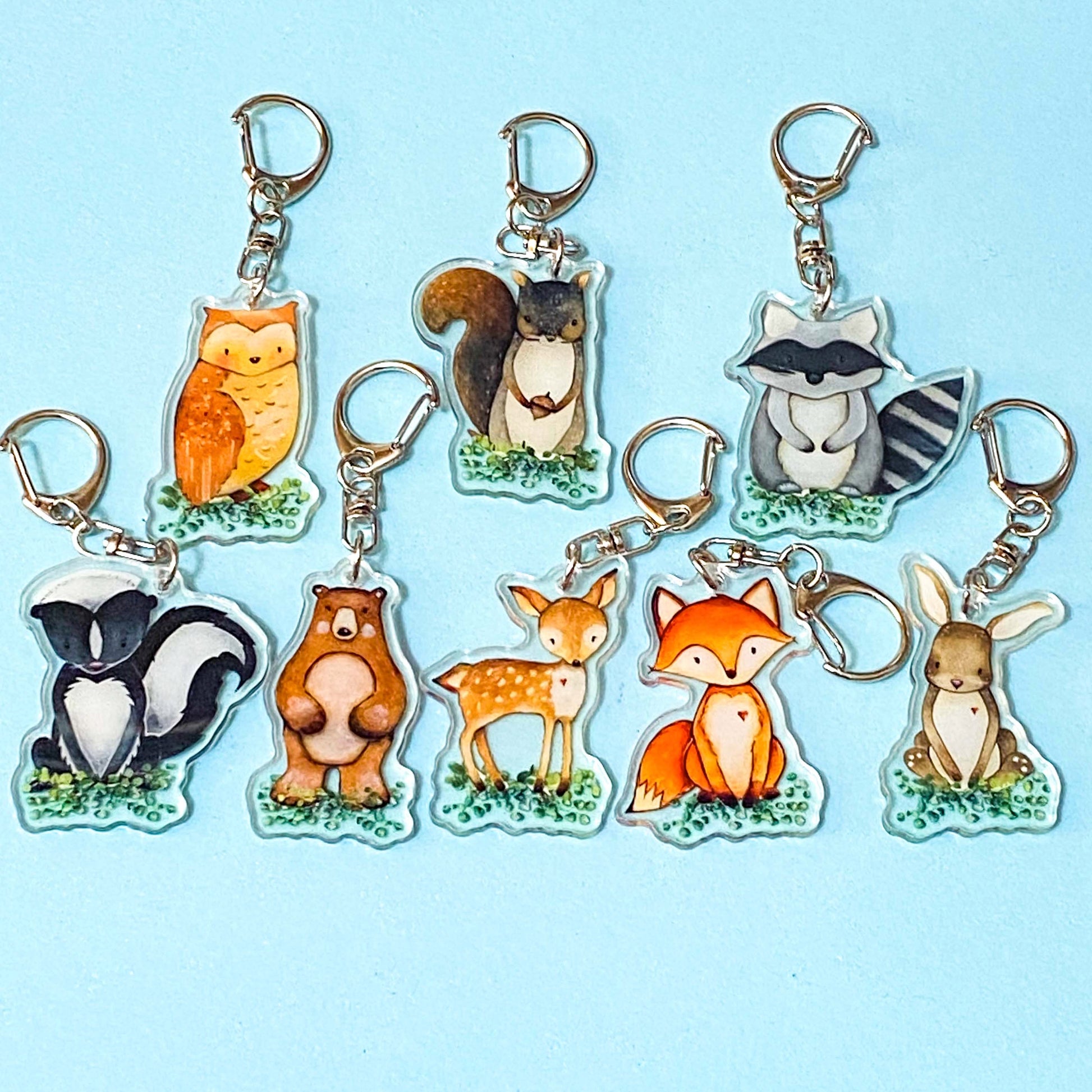 woodland animals clear acrylic keyrings clips on a blue background