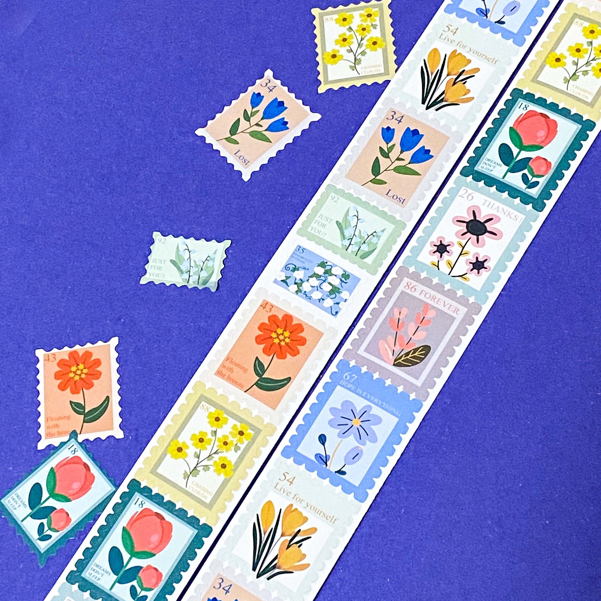 Decorative postage stamp stickers with floral designs on a blue background
