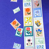 Decorative postage stamps stickers with floral designs on a blue background