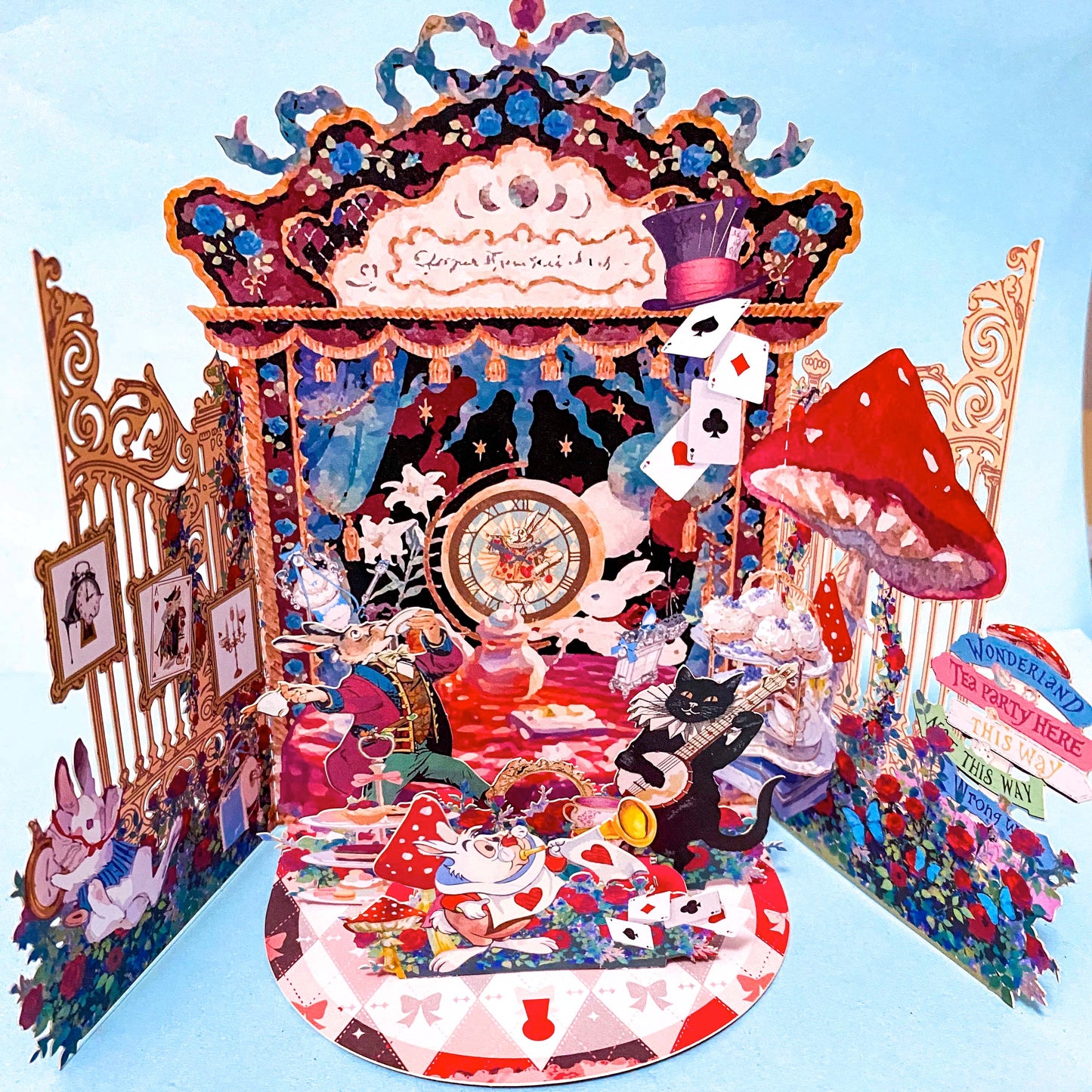 alice in wonderland themed pop up 3d greeting card with tea party scene, white rabbit, mushroom, playing cards and layered theatrical paper design.