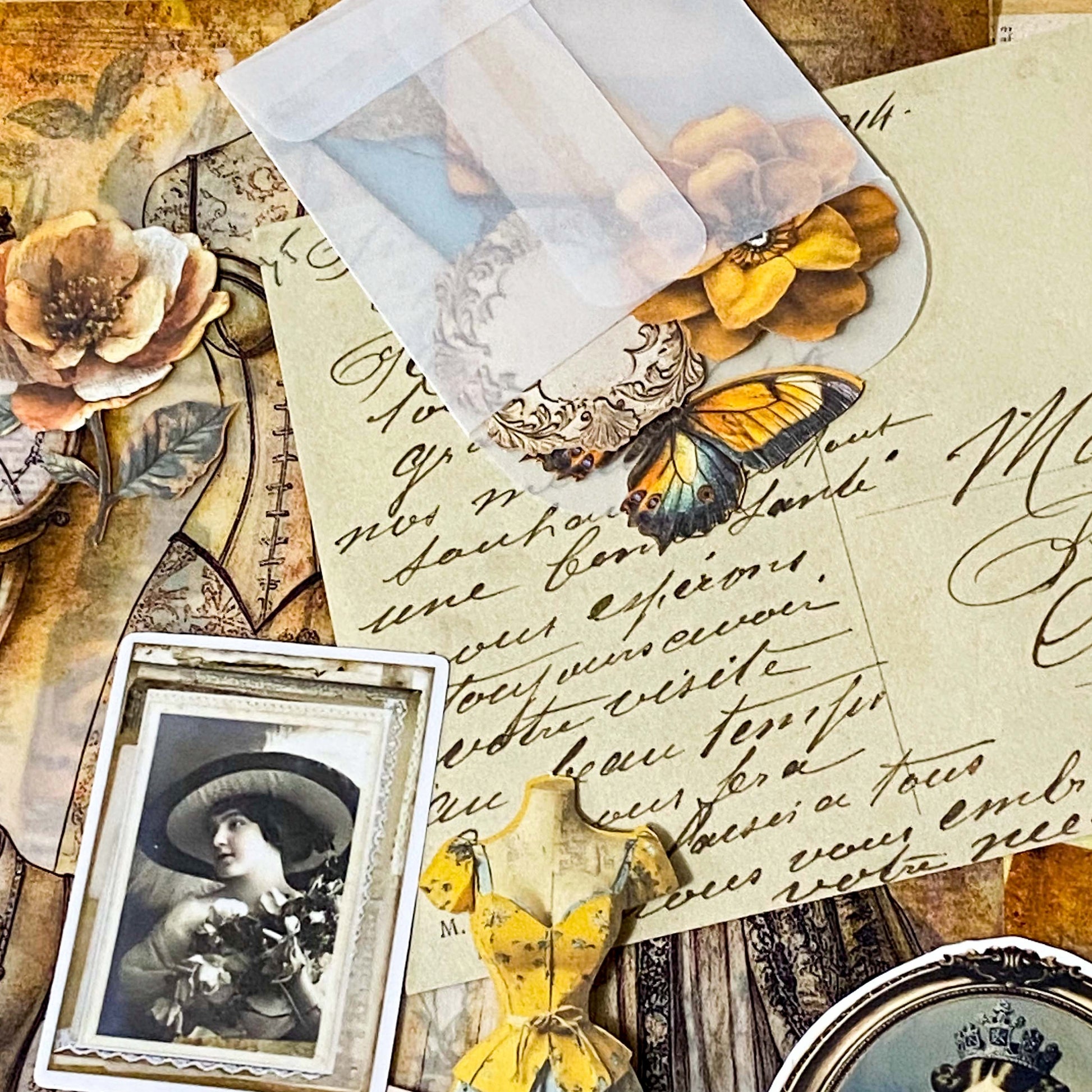 vintage scrapbooking ephemera bundle with victorian portrait stickers, antique papers, vellum sheets, mini envelopes and ornate key on neutral background