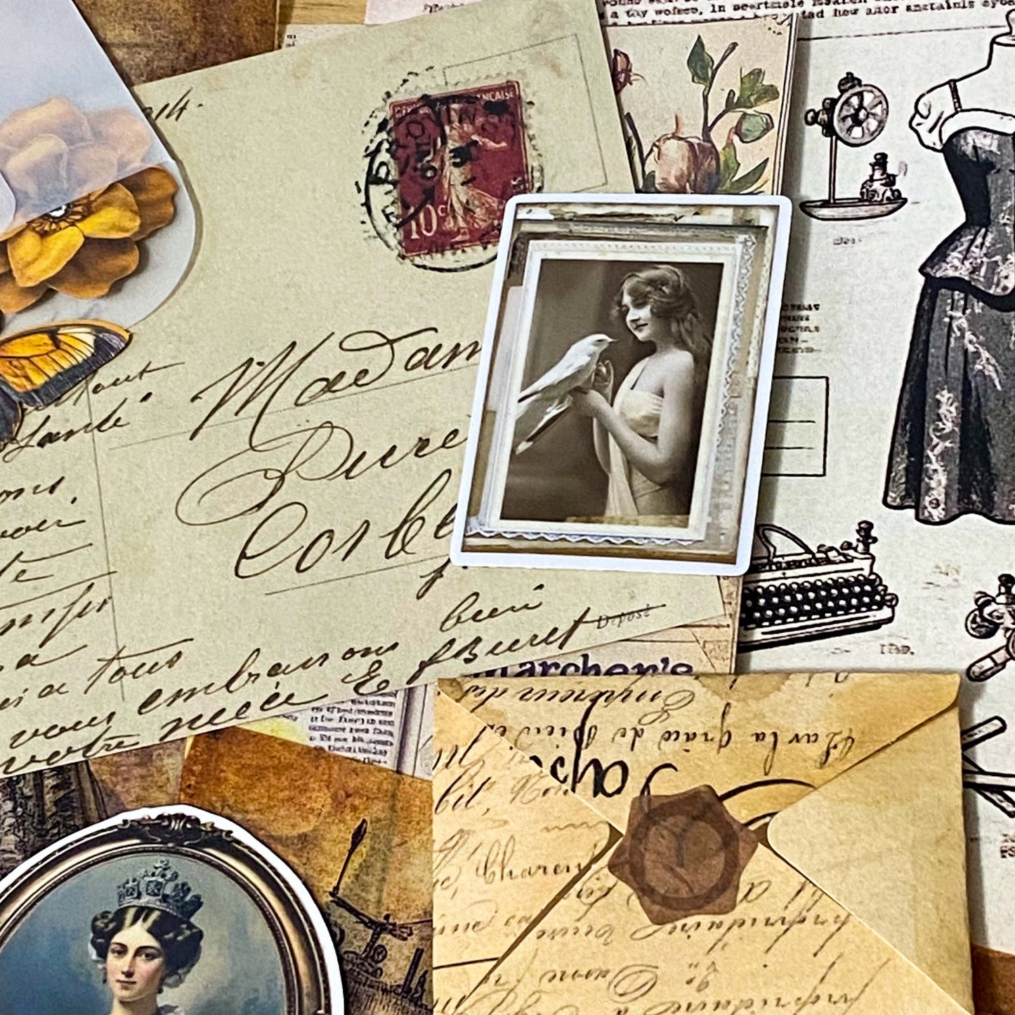 vintage scrapbooking ephemera bundle with victorian portrait stickers, antique papers, vellum sheets, mini envelopes and ornate key on neutral background