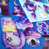 pack of 50 magical fantasy stickers featuring crystal balls, spell books, moonlit scrolls, enchanted mushrooms, ravens, potion bottles, celestial moons, magical animals and crystal gardens in lavender, violet and blue tones. UK stationery shop and letterbox gifts store.