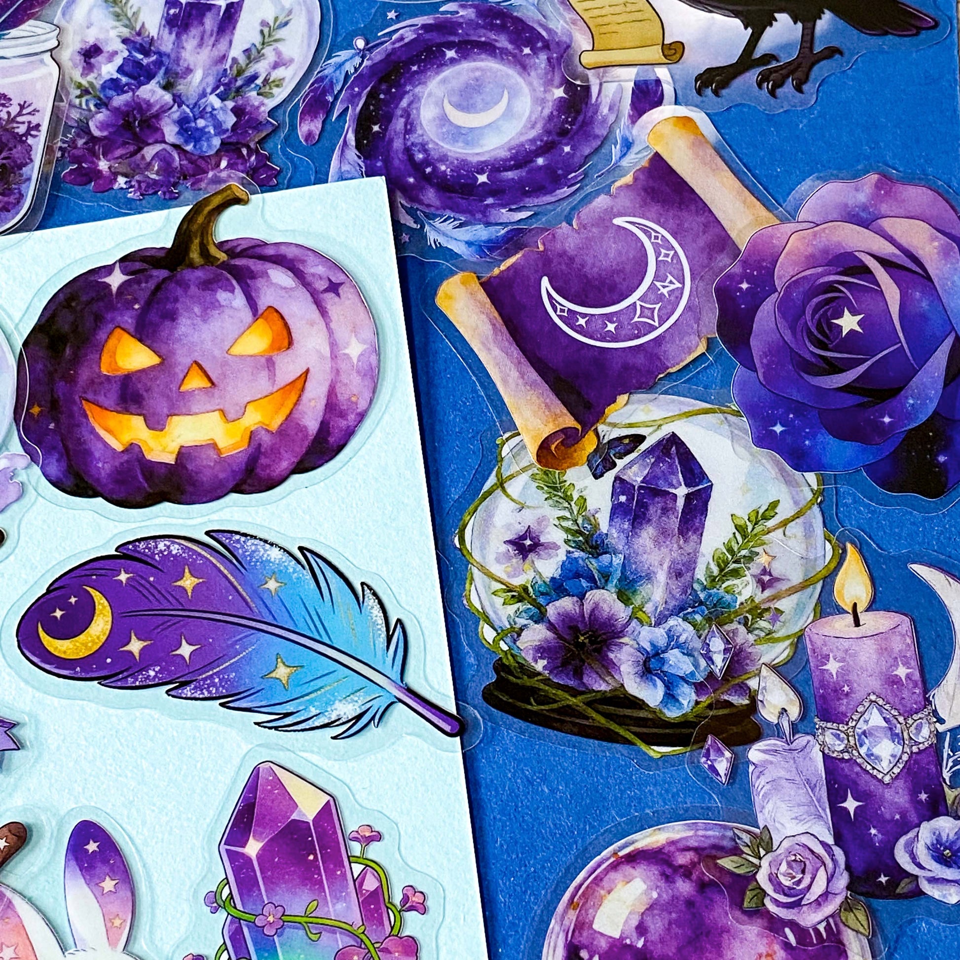 pack of 50 magical fantasy stickers featuring crystal balls, spell books, moonlit scrolls, enchanted mushrooms, ravens, potion bottles, celestial moons, magical animals and crystal gardens in lavender, violet and blue tones. UK stationery shop and letterbox gifts store.