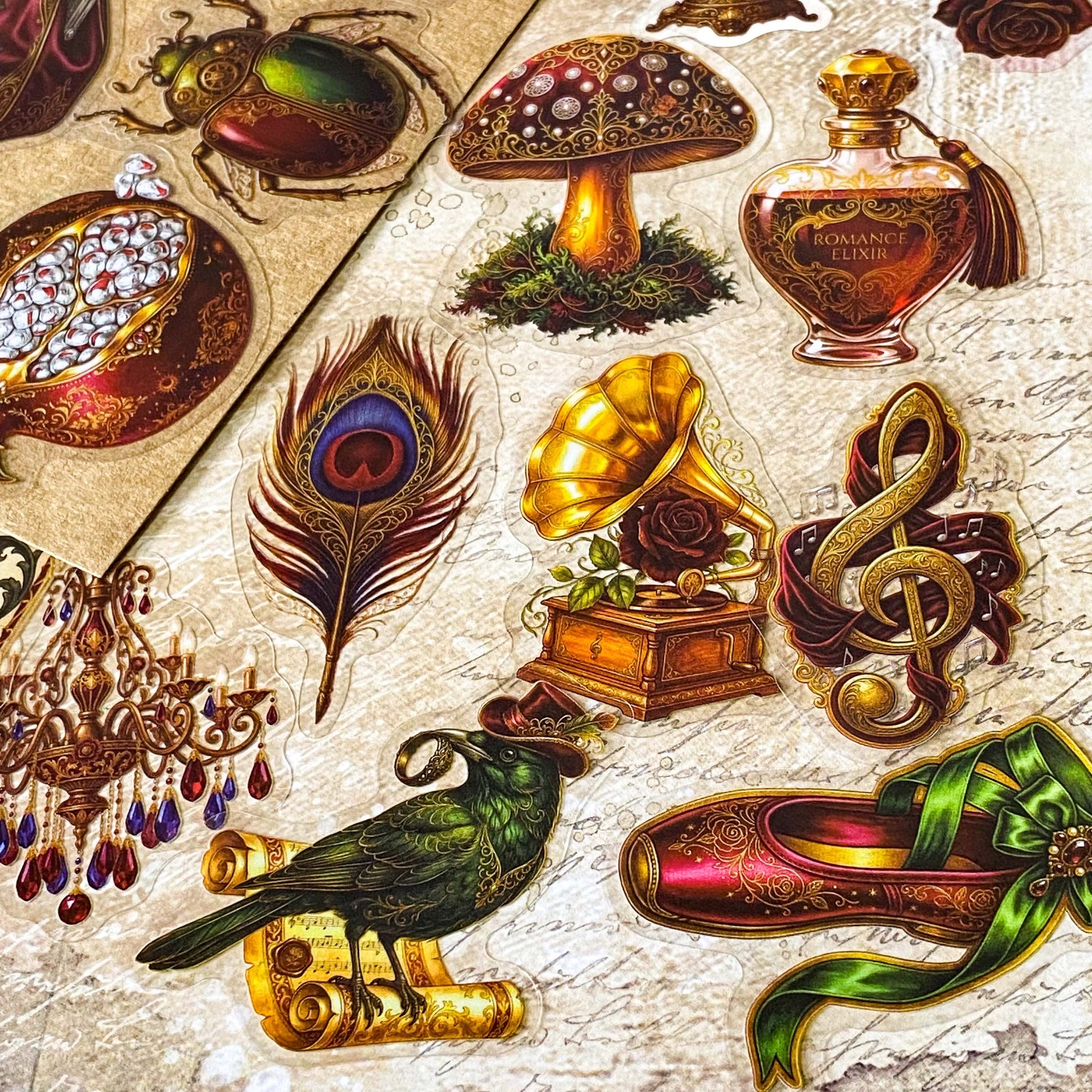 pack of 50 victorian inspired clear PET ephemera stickers featuring antique books, clocks, perfume bottles, roses, swans, butterflies, crowns, handwritten letters and curiosity cabinet treasures in rich dark burgundy, gold, green and midnight blue tones. Uk stationery shop.