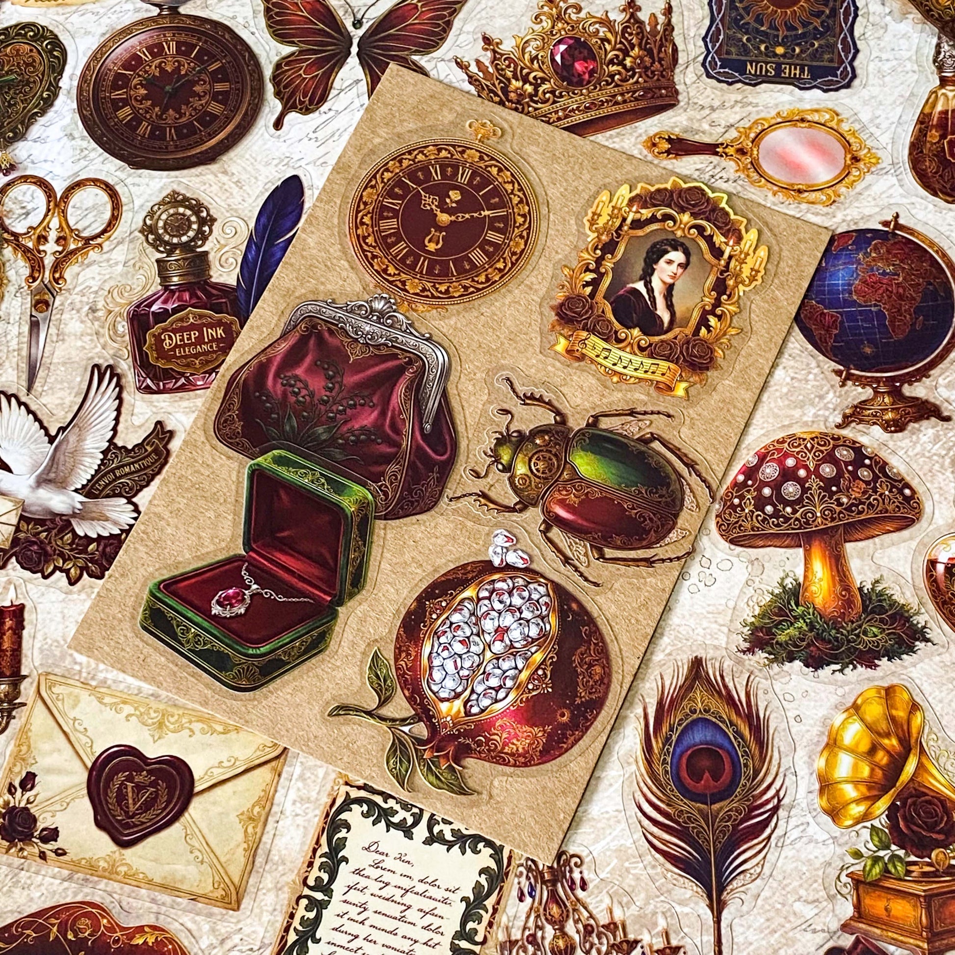 pack of 50 victorian inspired clear PET ephemera stickers featuring antique books, clocks, perfume bottles, roses, swans, butterflies, crowns, handwritten letters and curiosity cabinet treasures in rich dark burgundy, gold, green and midnight blue tones. Uk stationery shop.