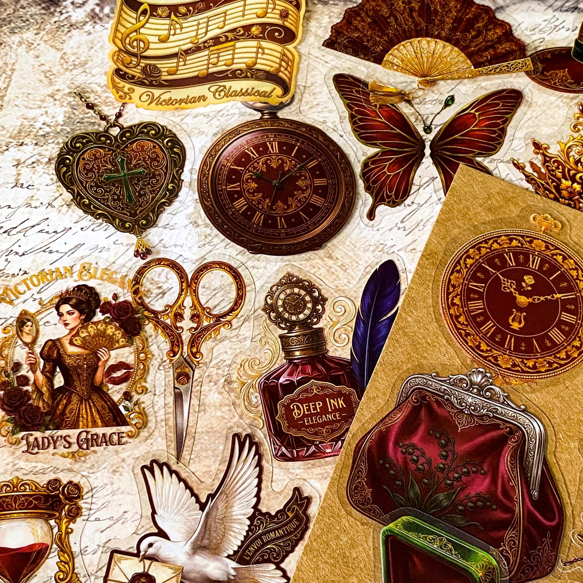 pack of 50 victorian inspired clear PET ephemera stickers featuring antique books, clocks, perfume bottles, roses, swans, butterflies, crowns, handwritten letters and curiosity cabinet treasures in rich dark burgundy, gold, green and midnight blue tones. Uk stationery shop.