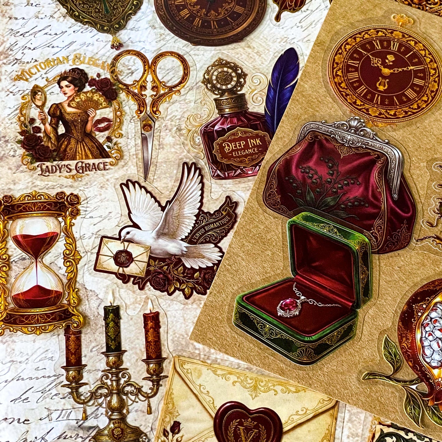 pack of 50 victorian inspired clear PET ephemera stickers featuring antique books, clocks, perfume bottles, roses, swans, butterflies, crowns, handwritten letters and curiosity cabinet treasures in rich dark burgundy, gold, green and midnight blue tones. Uk stationery shop.