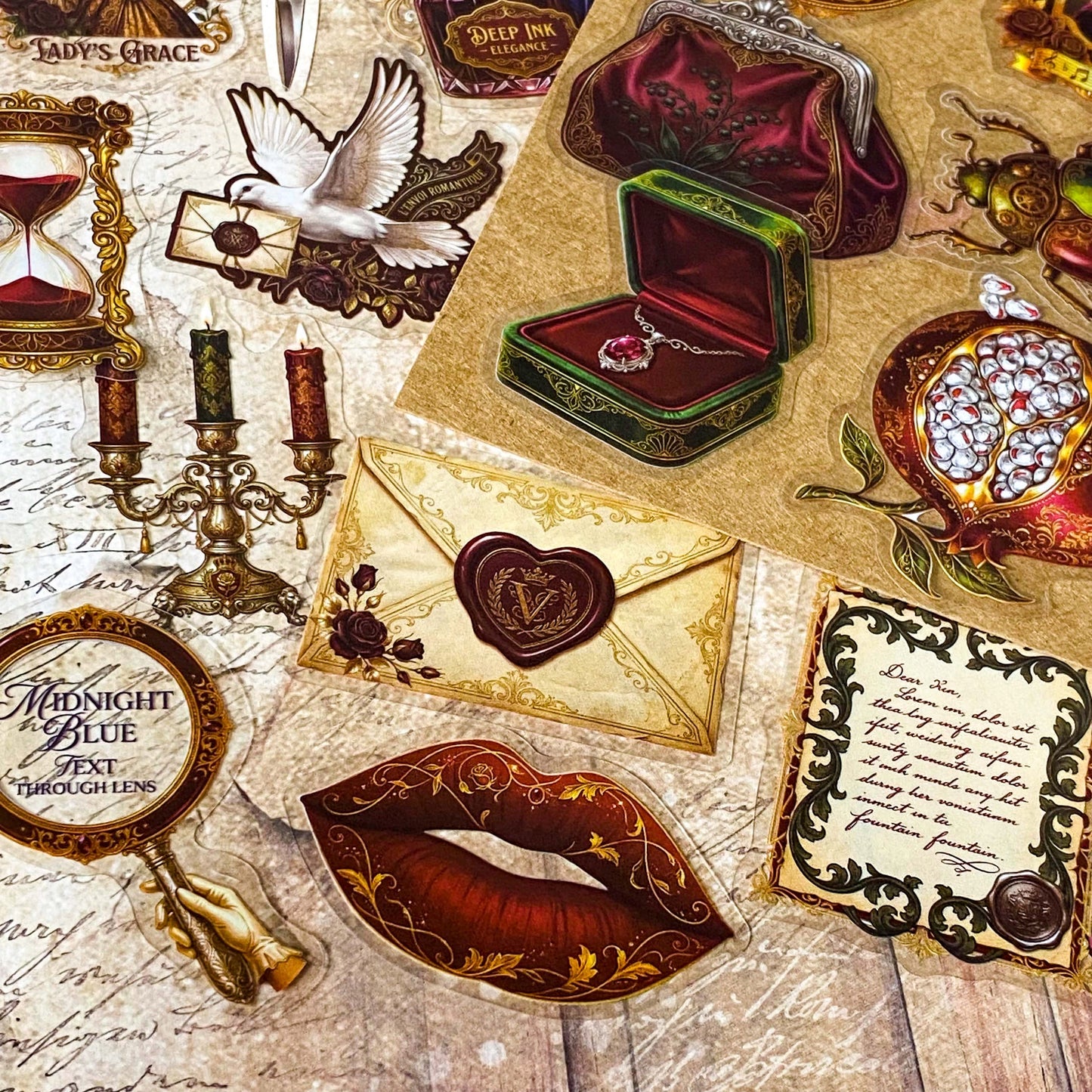 pack of 50 victorian inspired clear PET ephemera stickers featuring antique books, clocks, perfume bottles, roses, swans, butterflies, crowns, handwritten letters and curiosity cabinet treasures in rich dark burgundy, gold, green and midnight blue tones. Uk stationery shop.