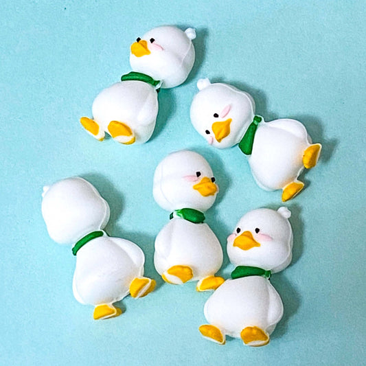 white silicone duck large beads on a blue backgroound