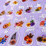 Pattern of glass jars plastic stickers with flowers on a purple background