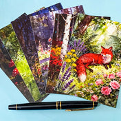 woodland fox postcard bundle with magical flowers, trees, girls and mushrooms on a blue background