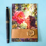 set of 4 cottage garden postcards featuring floral artwork, a girl in a garden, wrapped by a kraft belly band and wax seal sticker on a blue background
