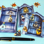 nature themed magic cabinet ephemera set with blue illustrated cabinet shelves and 22 paper cut put pieces including moths, insects and specimen bottles on a blue background with a pen