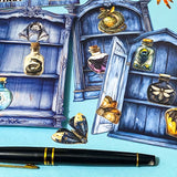 nature themed magic cabinet ephemera set with blue illustrated cabinet shelves and 22 paper cut put pieces including moths, insects and specimen bottles on a blue background with a pen