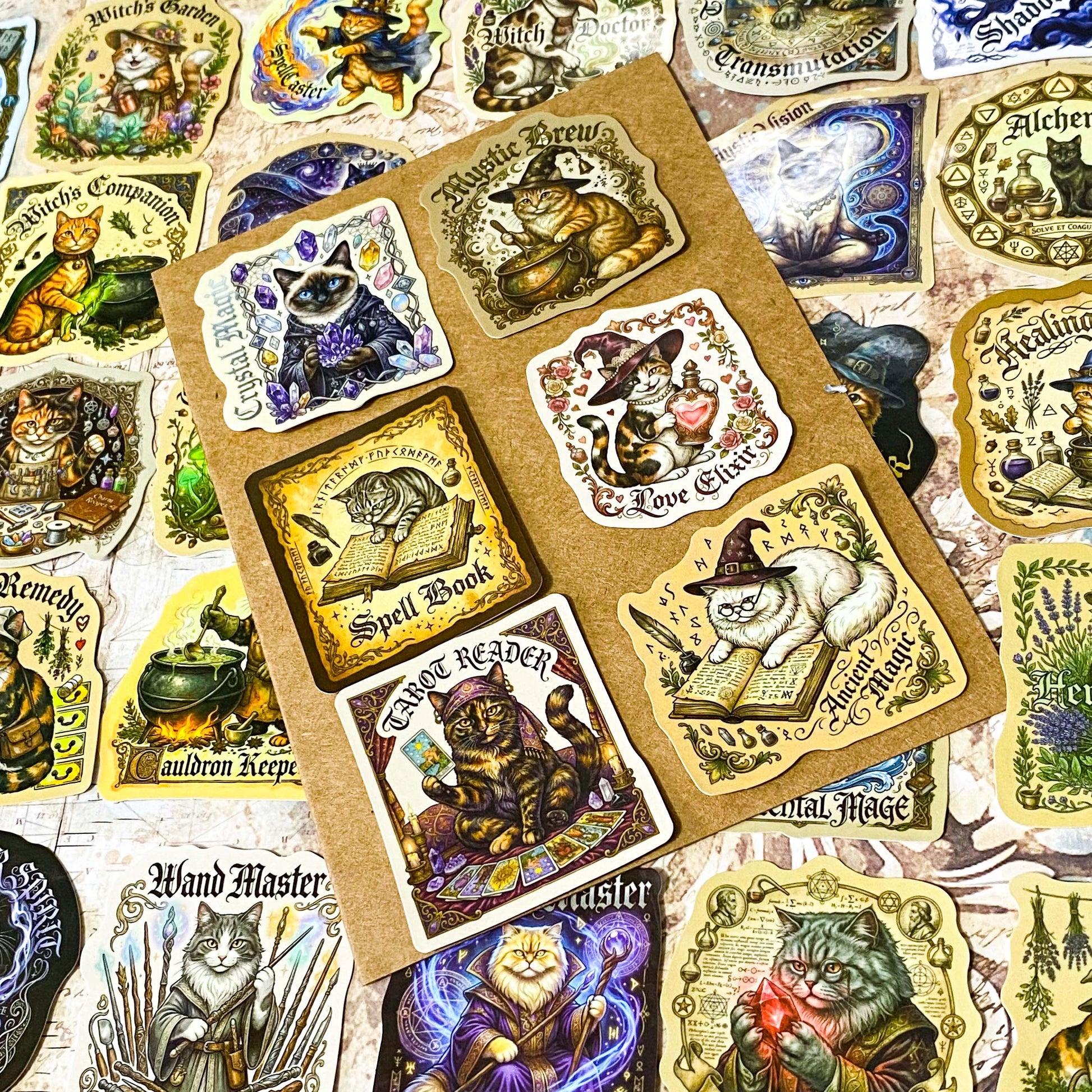 glossy witchy cat stickers spread out showing magical designs including potion cats, astrology, spell books and crystal ball illustrations in vintage style