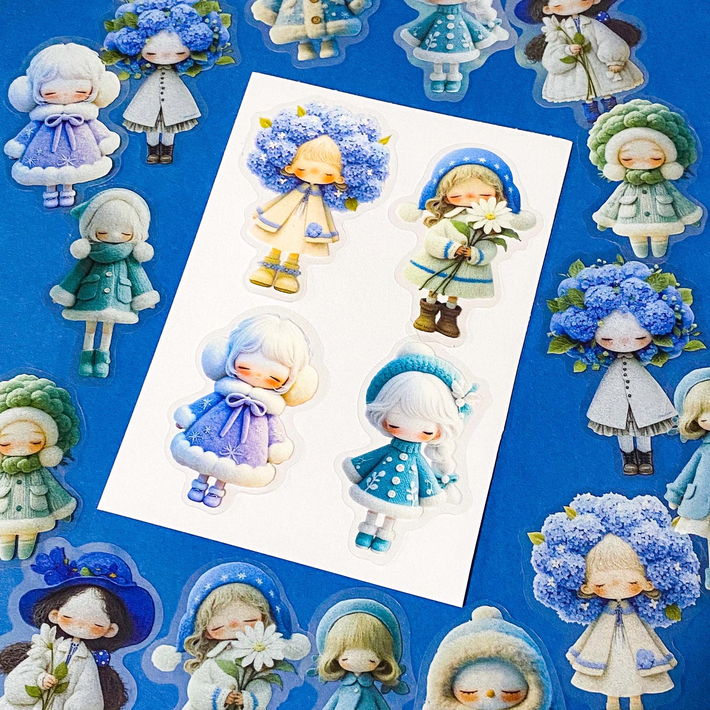 blue themed large PET doll stickers with kawaii illustrations including flowers, hydrangea, cosy winter outfits and turquoise dresses. Uk small business.