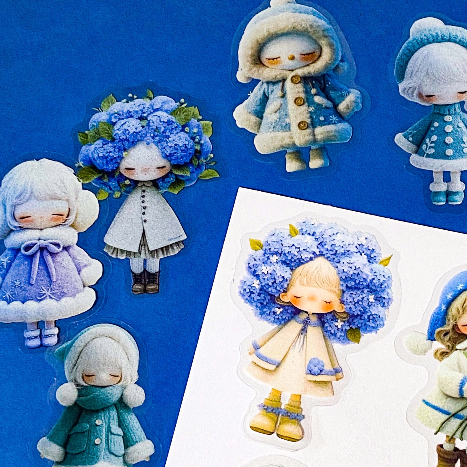 blue themed large PET doll stickers with kawaii illustrations including flowers, hydrangea, cosy winter outfits and turquoise dresses. Uk small business.