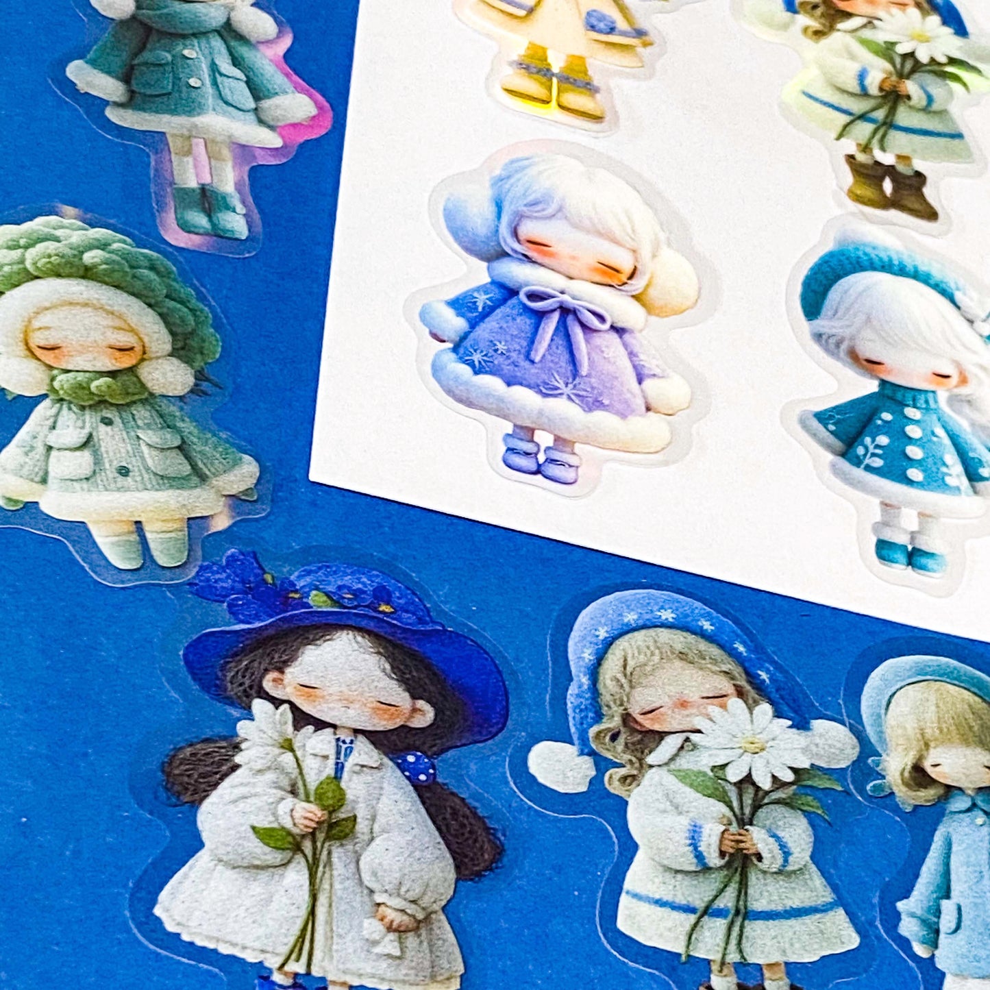blue themed large PET doll stickers with kawaii illustrations including flowers, hydrangea, cosy winter outfits and turquoise dresses. Uk small business.