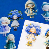 blue themed large PET doll stickers with kawaii illustrations including flowers, hydrangea, cosy winter outfits and turquoise dresses. Uk small business.