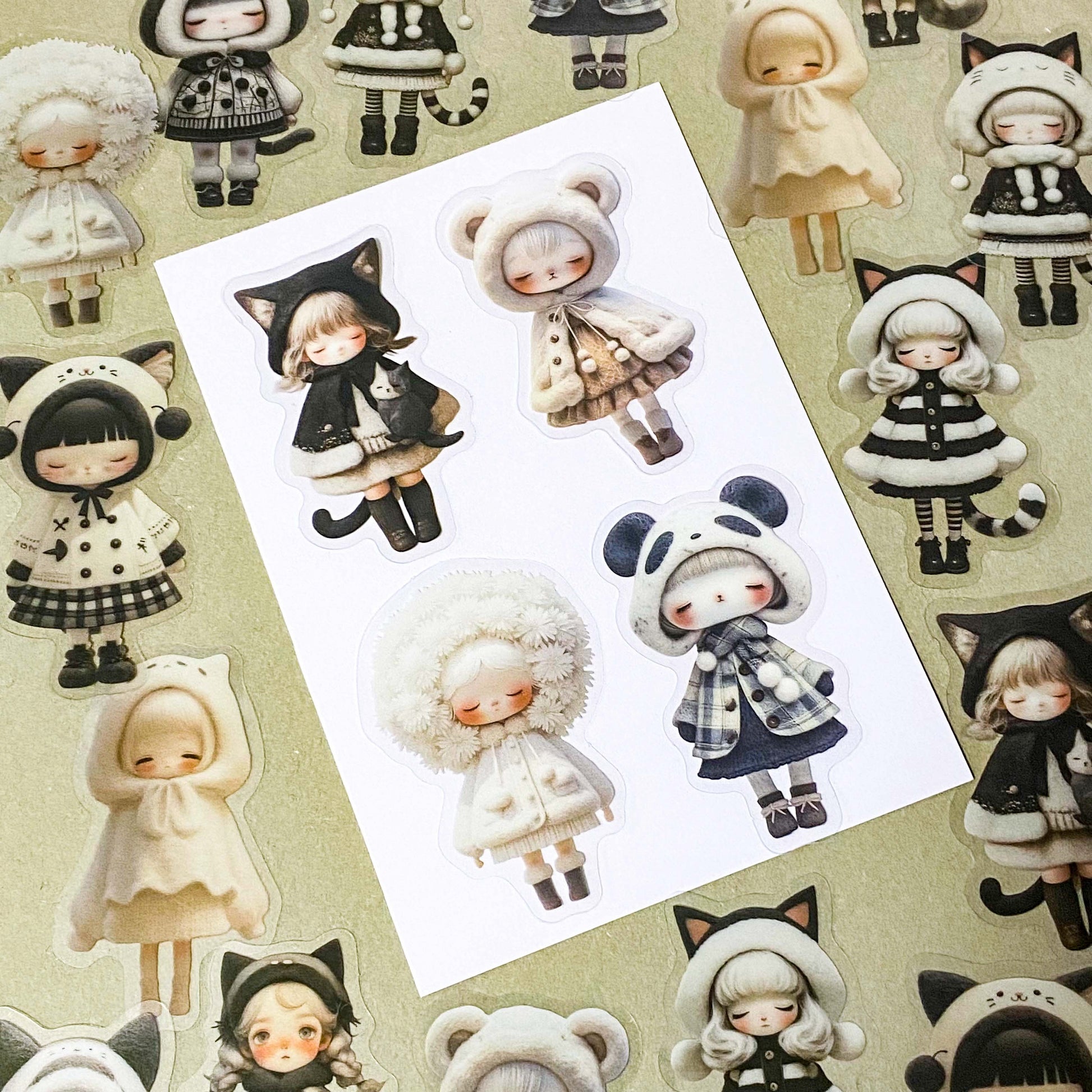 black and cream coloured large PET doll sticker set with cute animals including panda, cat and bear. Girls wearing cosy winter outfits with stripy stockings and furry hats. Uk small business selling kawaii stationery.