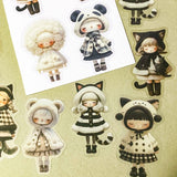 black and cream coloured large PET doll sticker set with cute animals including panda, cat and bear. Girls wearing cosy winter outfits with stripy stockings and furry hats. Uk small business selling kawaii stationery.
