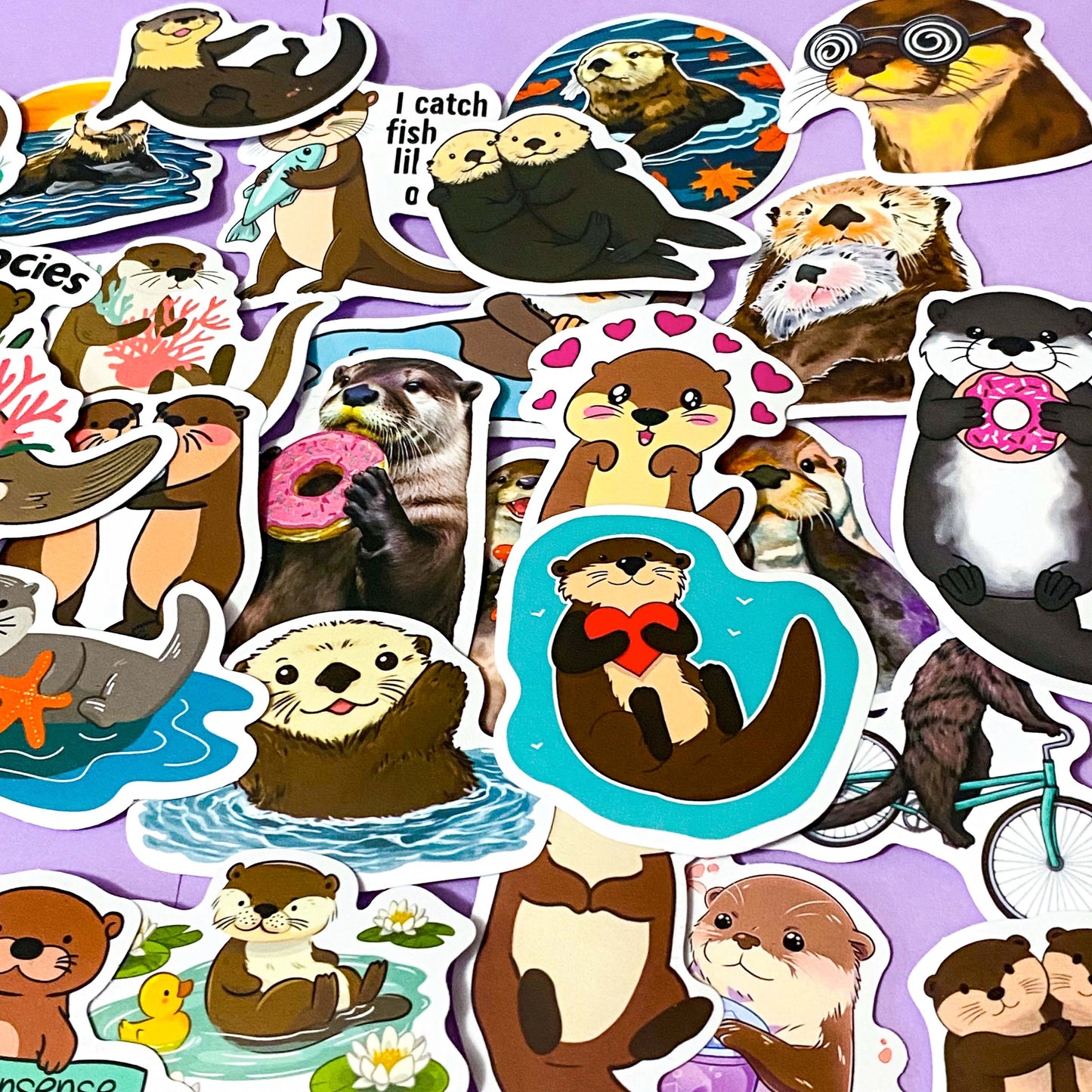 set of 50 cute otter laptop stickers in various styles including cartoon and funny designs on a lilac background