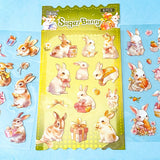 set of 6 kawaii bunny clear plastic sticker sheets with pastel rabbits, flowers and gift illustrations on a blue background