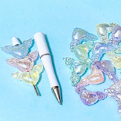 white pen base with winged heart iridescent acrylic large beads on a blue background