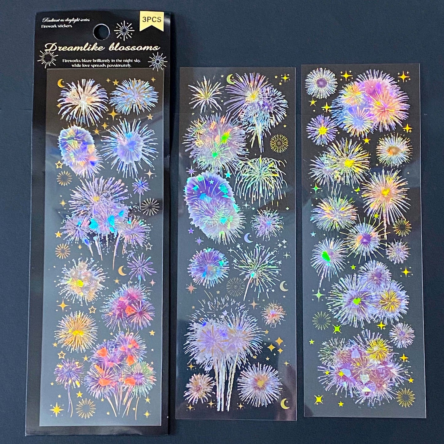 three iridescent firework sticker sheets with dreamy pink and purple and pastel holographic bursts on transparent PET material. uk cute stationery supplies