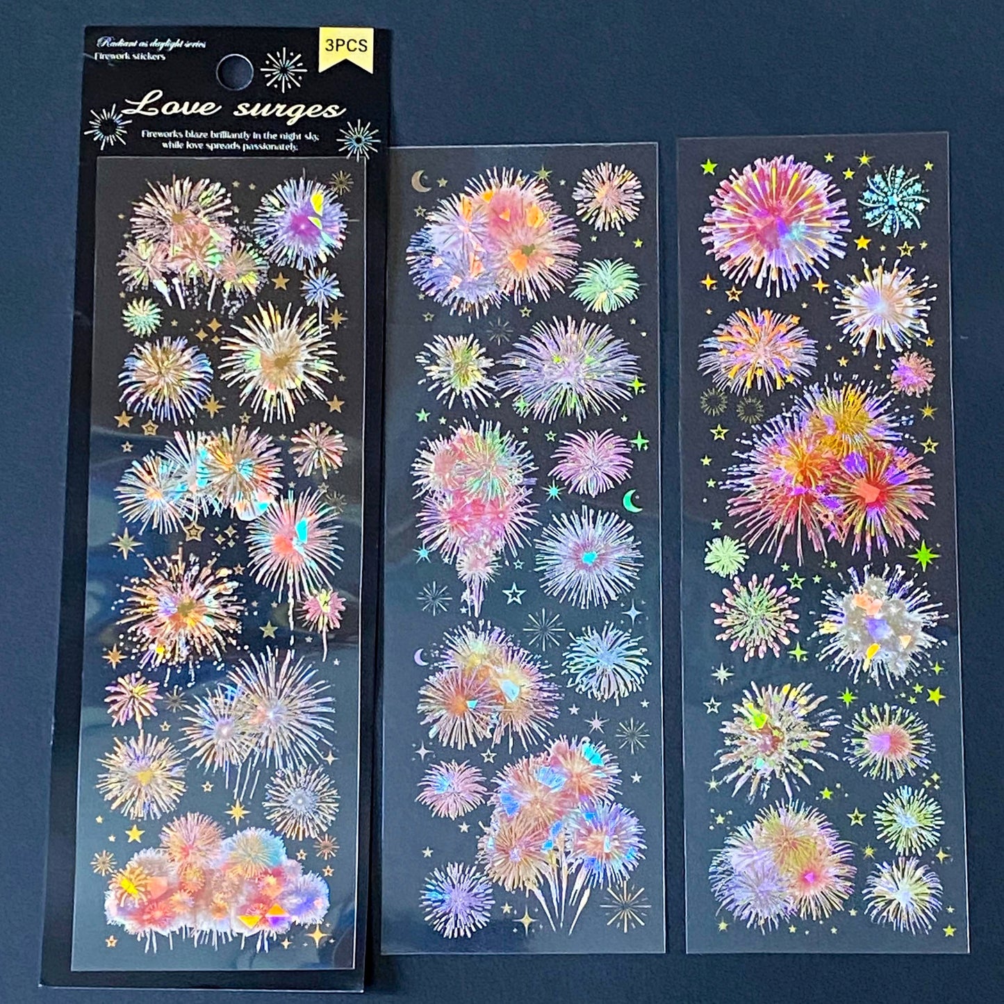 three clear holographic PET sticker sheets featuring colourful red and pink pastel fireworks and celestial night sky. uk cute stickers shop for planning and juornaling.