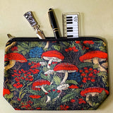 deep red canvas mushroom zip pouch featuring red toadstools, berries and botanical foliage on a dark forest background. Uk gift shop for letterbox gifts.
