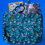midnight petals letterbox gift set featuring a dark blue and green floral tapestry pouch, botanical ballpoint pen, blank flower greetings card and envelope, floral crystal and butterfly bracelet and dark floral clear sticker pack. uk cute and beautiful gift shop.
