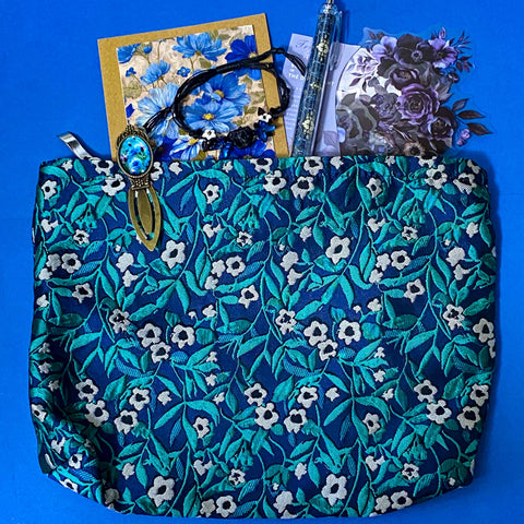 midnight petals letterbox gift set featuring a dark blue and green floral tapestry pouch, botanical ballpoint pen, blank flower greetings card and envelope, floral crystal and butterfly bracelet and dark floral clear sticker pack. uk cute and beautiful gift shop.