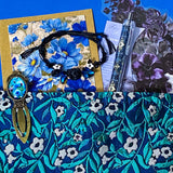midnight petals letterbox gift set featuring a dark blue and green floral tapestry pouch, botanical ballpoint pen, blank flower greetings card and envelope, floral crystal and butterfly bracelet and dark floral clear sticker pack. uk cute and beautiful gift shop.