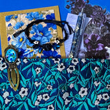 midnight petals letterbox gift set featuring a dark blue and green floral tapestry pouch, botanical ballpoint pen, blank flower greetings card and envelope, floral crystal and butterfly bracelet and dark floral clear sticker pack. uk cute and beautiful gift shop.