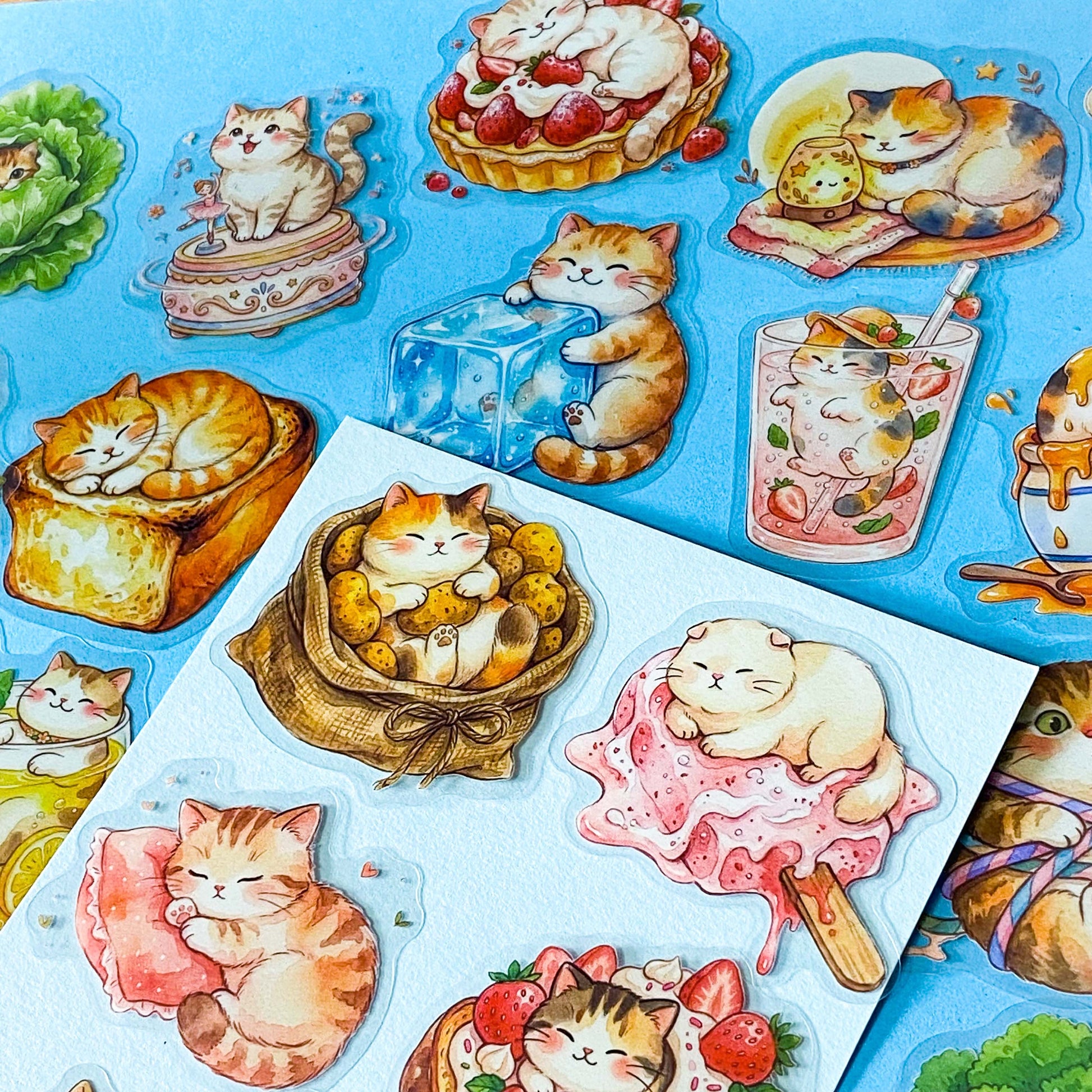 50 adorable watercolour PET cat stickers featuring sleepy kittens curled up in bread, desserts, fruit, drinks, mushrooms, moon, vegetables, clouds and cosy scenes. Uk stationery gift shop.