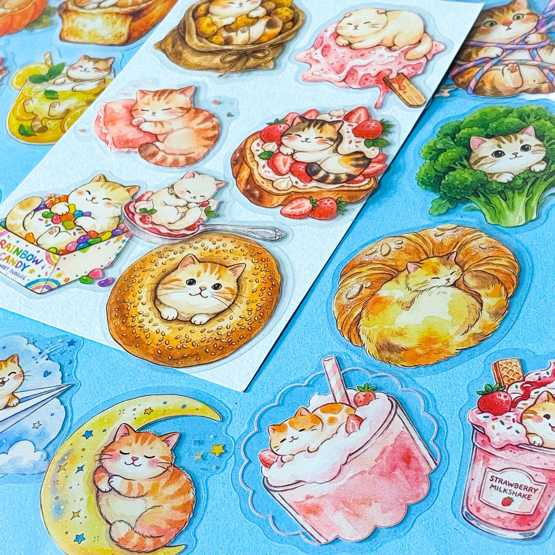 50 adorable watercolour PET cat stickers featuring sleepy kittens curled up in bread, desserts, fruit, drinks, mushrooms, moon, vegetables, clouds and cosy scenes. Uk stationery gift shop.