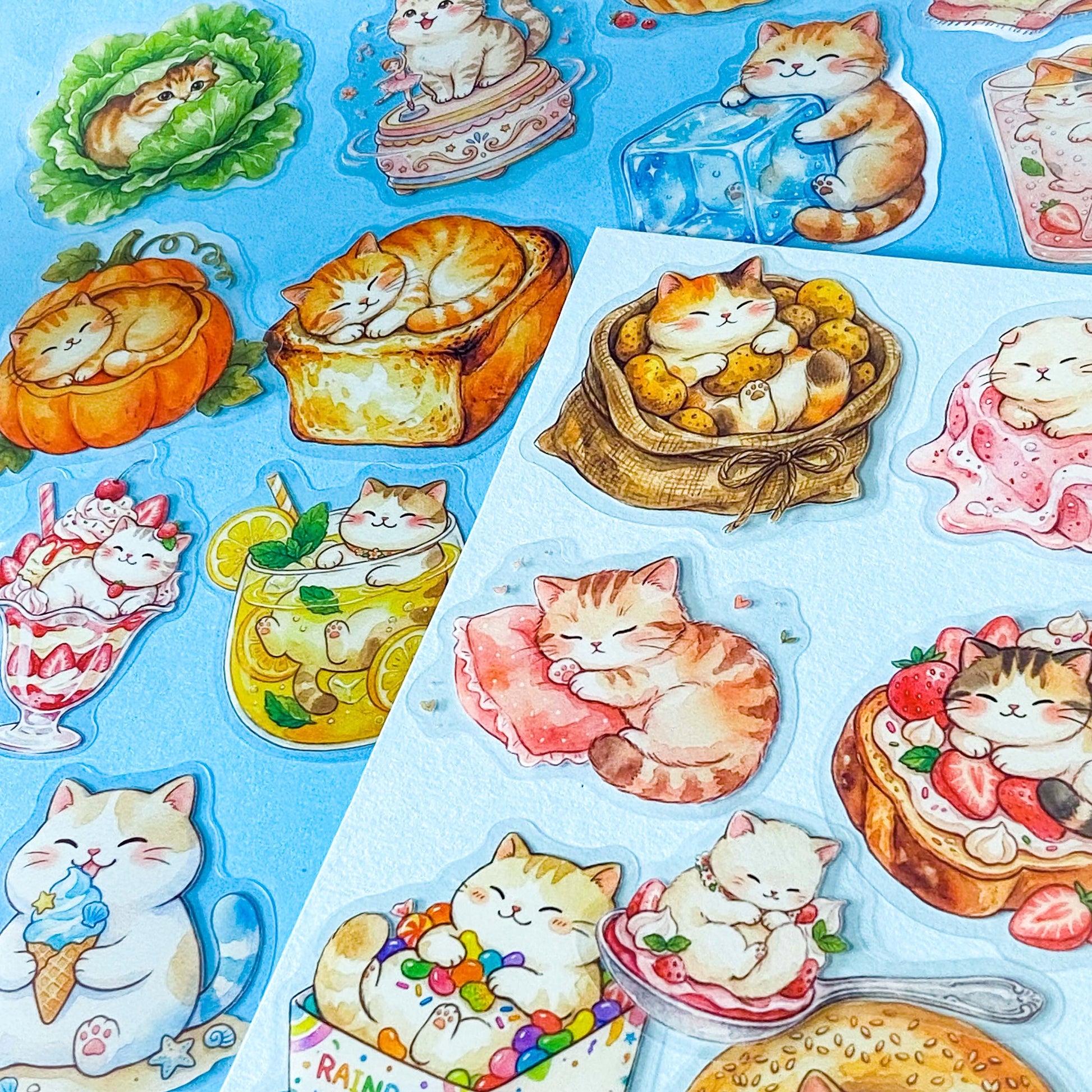 50 adorable watercolour PET cat stickers featuring sleepy kittens curled up in bread, desserts, fruit, drinks, mushrooms, moon, vegetables, clouds and cosy scenes. Uk stationery gift shop.
