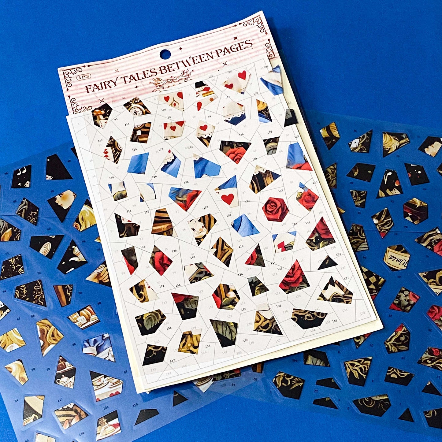 alice in wonderland inspired mosaic puzzle sticker craft kit with numbered template sheet and transparent PET sticker pieces revealing a whimsical tea party illustration