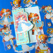 large nutcracker- inspired clear PET sticker pack featuring ballet princess illustrations, toy soldiers, ribbons, clocks and ornate storybook artwork in blue and gold tones with red.