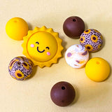 sunny yellow and dark brown silicone beads mix with sunshine jumbo 27mm focal bead and patterned sunflower design 16mm beads. uk craft supplies shop.