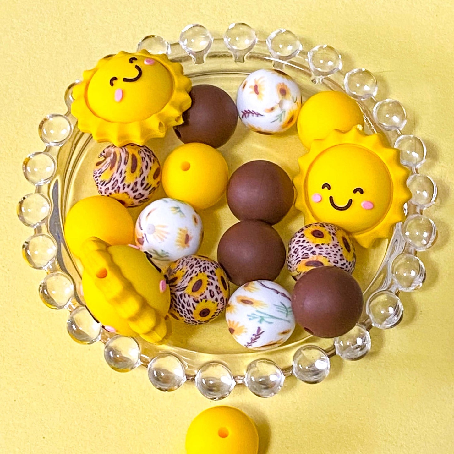 sunny yellow and dark brown silicone beads mix with sunshine jumbo 27mm focal bead and patterned sunflower design 16mm beads. uk craft supplies shop.