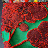 strawberries and red roses letterbox gift set featuring a lined emerald green and crimson floral pouch, rose sticker sheets, floral acrylic bookmark with tassel, red metallic pen, romantic postcards and enamel strawberry brooch. Uk letterbox gifts shop.