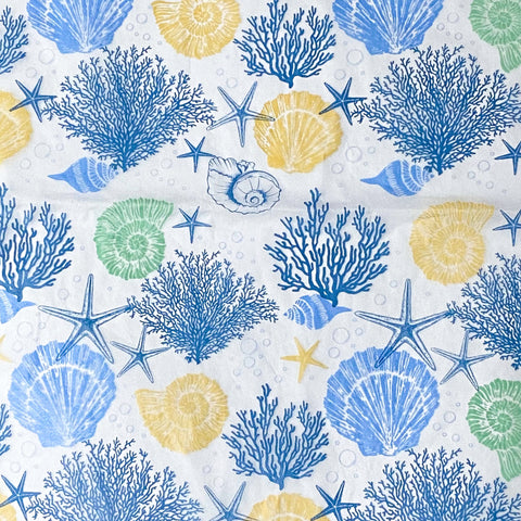 Seashell, starfish, and coral pattern tissue paper sheets on a white background