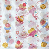 pastel tissue paper with a cute bows, cakes and ice creams pattern on white