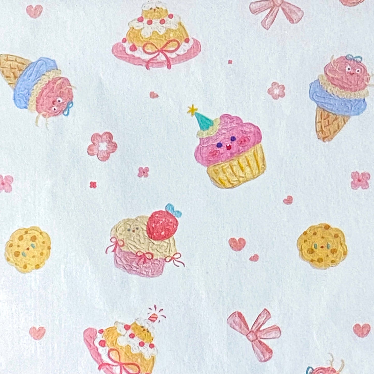 tissue paper sheets with a pastel cakes and bows pattern on white