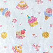 tissue paper sheets with a pastel cakes and bows pattern on white